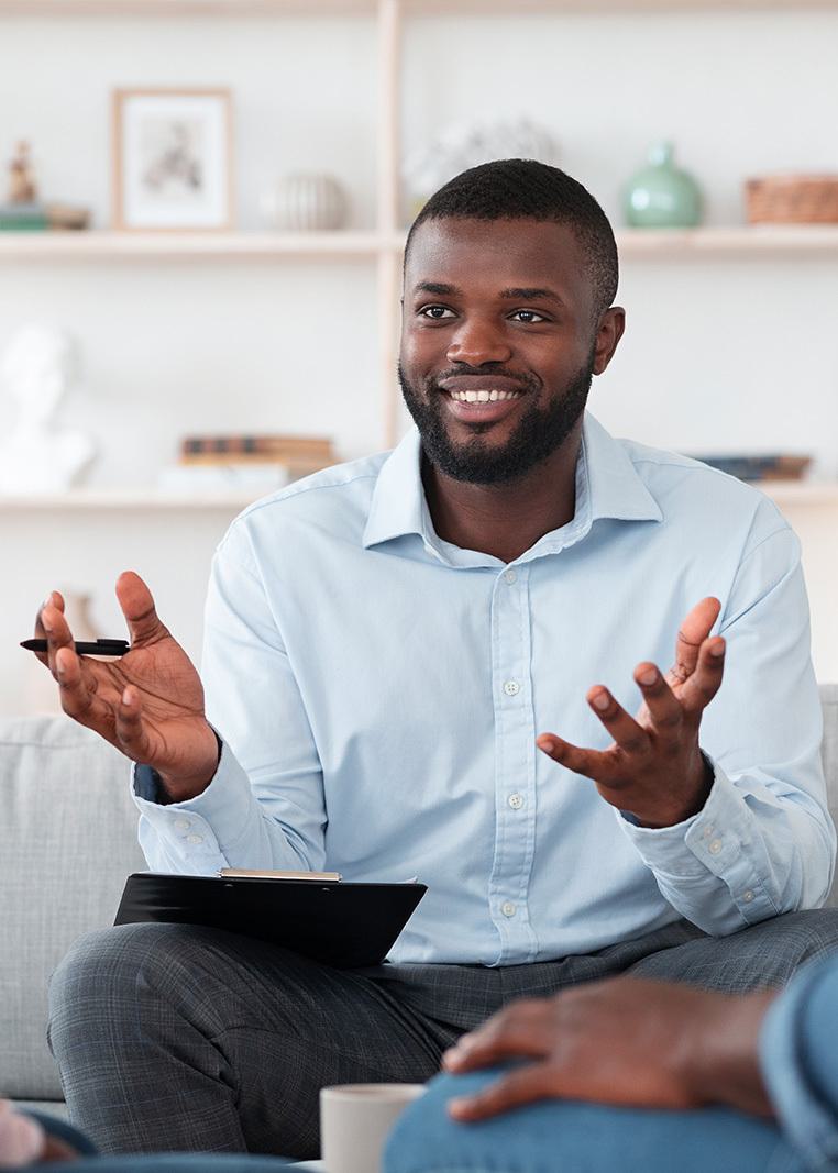 seated smiling male talking with gesturing hands